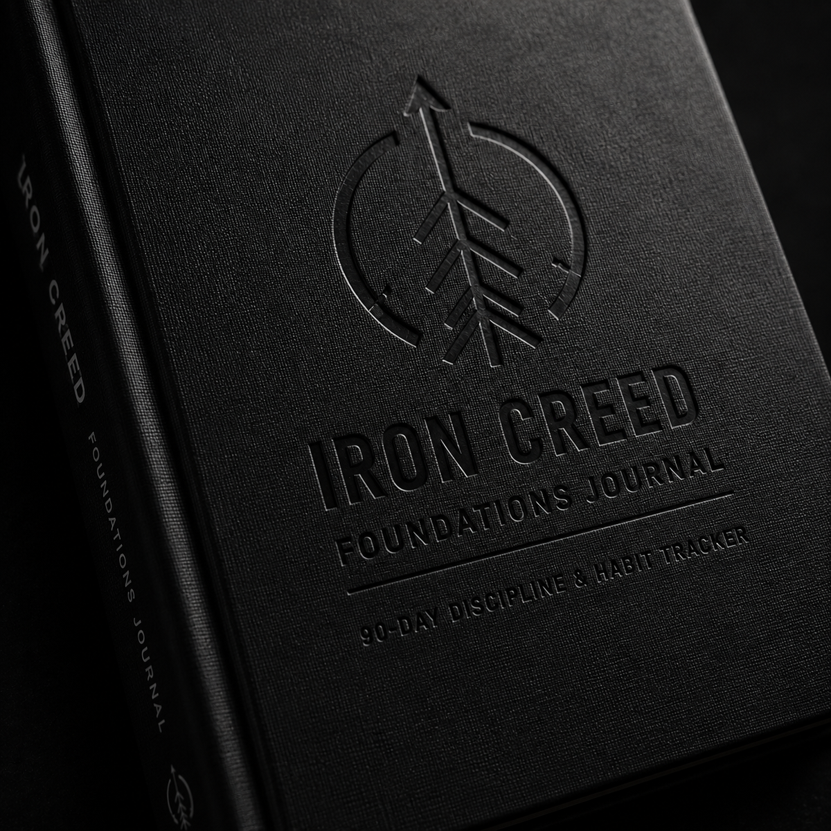 Close-up cover mockup showing the embossed Iron Creed Foundations Journal logo and title